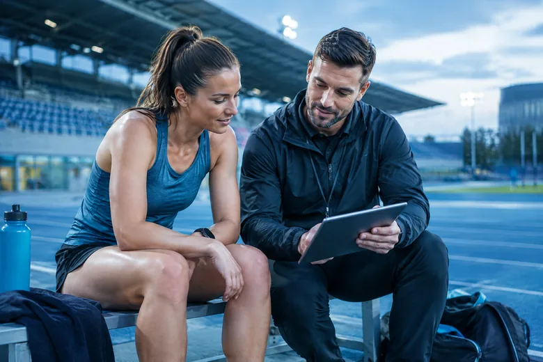 Athlete and performance staff discuss recovery at training; editorial illustration