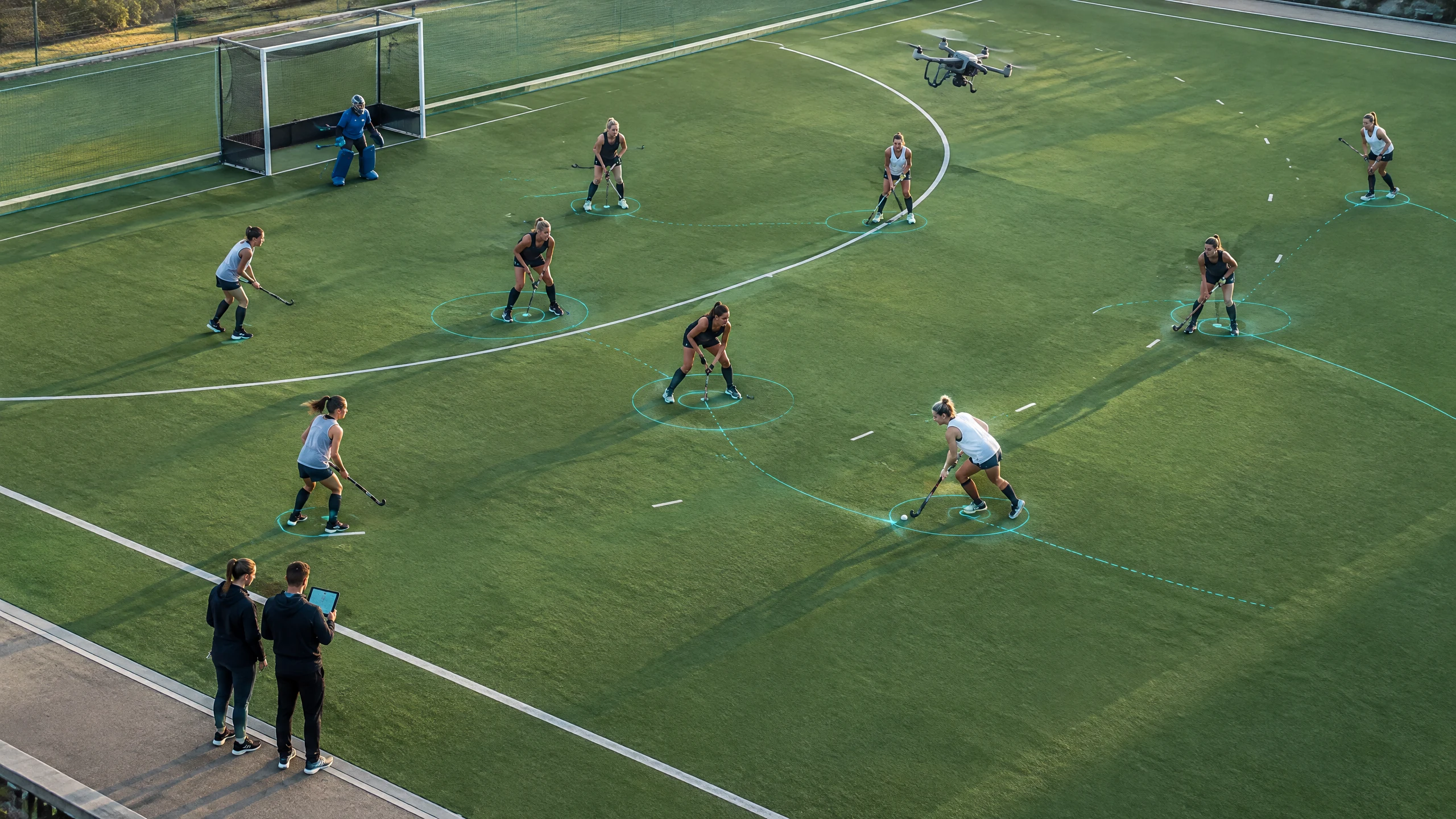 Coaches review drone-captured positioning during a women’s field-hockey training drill.